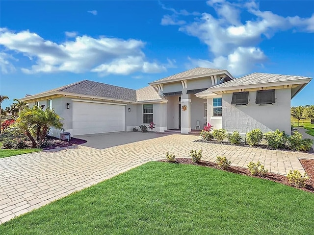 view of front of house featuring a front yard and a garage