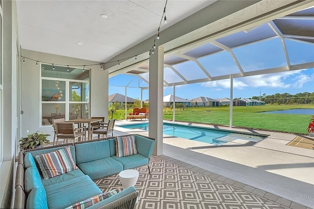 view of swimming pool with an outdoor living space, a patio, a lanai, and a lawn