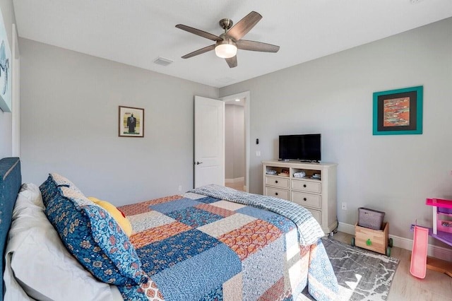 bedroom with hardwood / wood-style flooring and ceiling fan