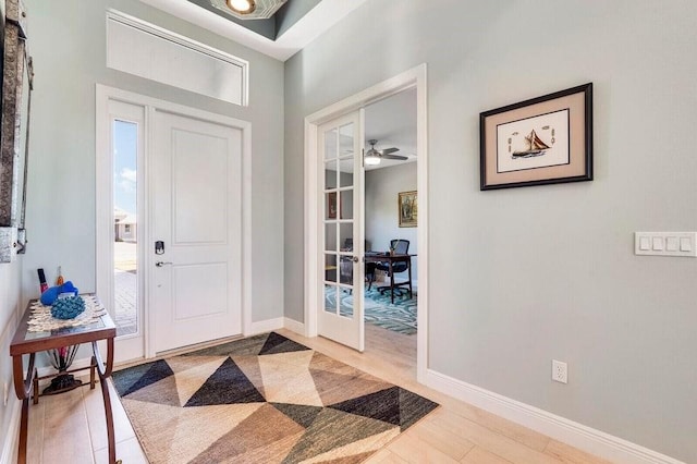 entryway with ceiling fan and light hardwood / wood-style flooring