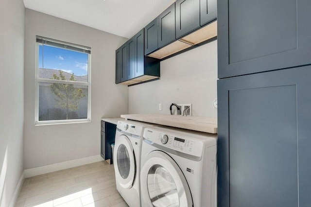 washroom featuring cabinets and independent washer and dryer