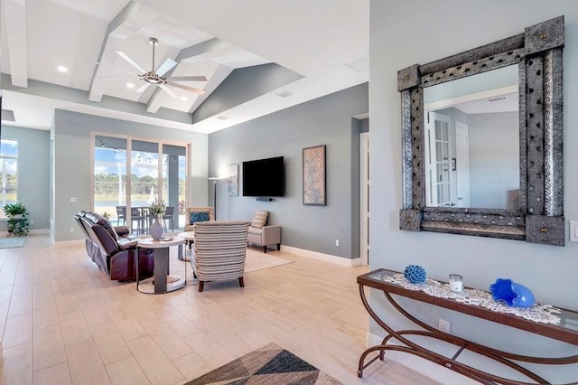 living room featuring ceiling fan, light wood-type flooring, and vaulted ceiling