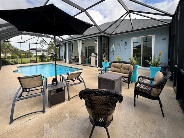 view of swimming pool with glass enclosure, ceiling fan, an outdoor hangout area, and a patio area