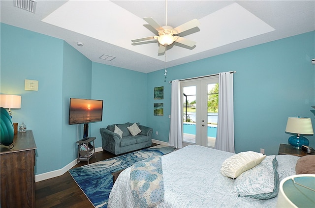 bedroom featuring access to exterior, french doors, dark hardwood / wood-style flooring, and ceiling fan