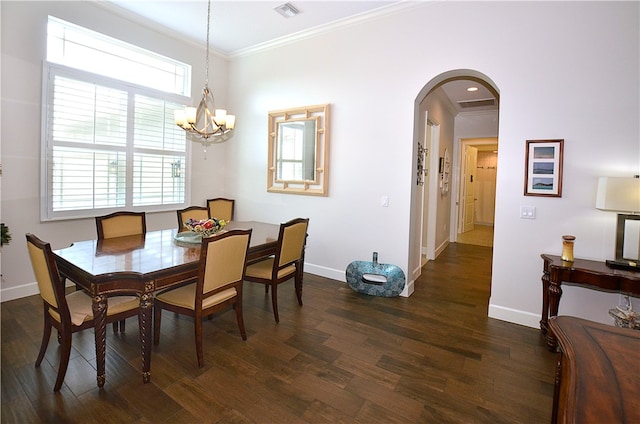 dining room with ornamental molding, a healthy amount of sunlight, a notable chandelier, and dark hardwood / wood-style floors