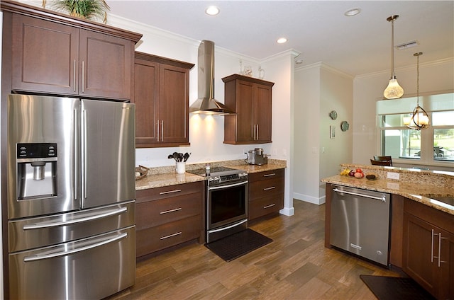 kitchen with light stone counters, appliances with stainless steel finishes, ornamental molding, wall chimney exhaust hood, and dark wood-type flooring