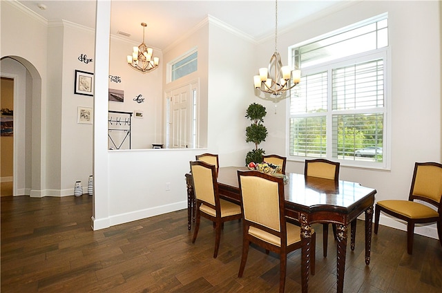 dining space featuring dark hardwood / wood-style flooring, a chandelier, and crown molding