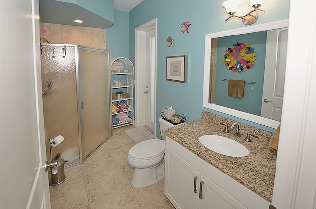 bathroom featuring vanity, a shower with shower door, tile patterned flooring, and toilet