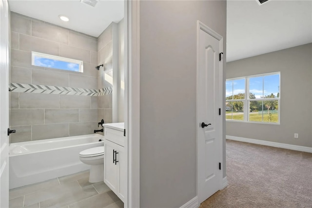 full bathroom with tiled shower / bath, vanity, and toilet