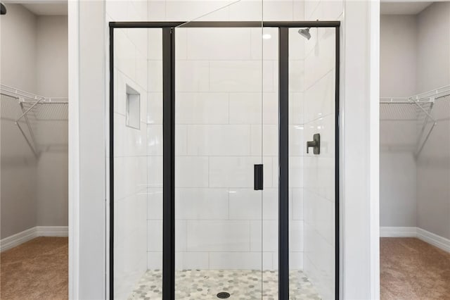 bathroom featuring a shower with door