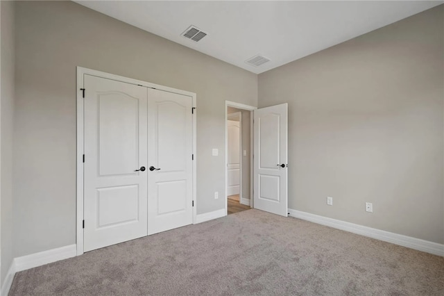 unfurnished bedroom featuring a closet and carpet flooring