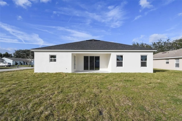 rear view of house with a yard and a patio