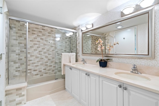 bathroom featuring tile patterned flooring, enclosed tub / shower combo, and vanity