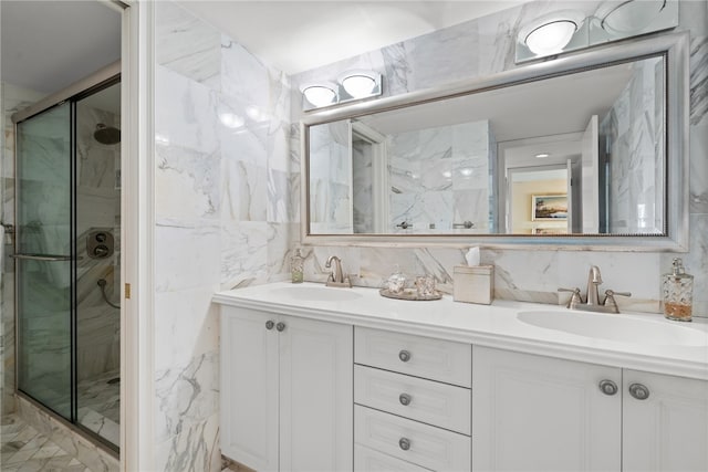 bathroom with vanity, an enclosed shower, and tile walls