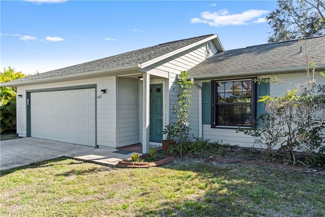 ranch-style house featuring a garage and a front lawn