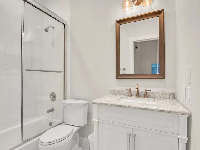 full bathroom with toilet, combined bath / shower with glass door, and vanity