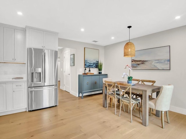 dining area featuring light wood-type flooring