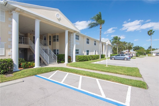 view of parking / parking lot with a yard