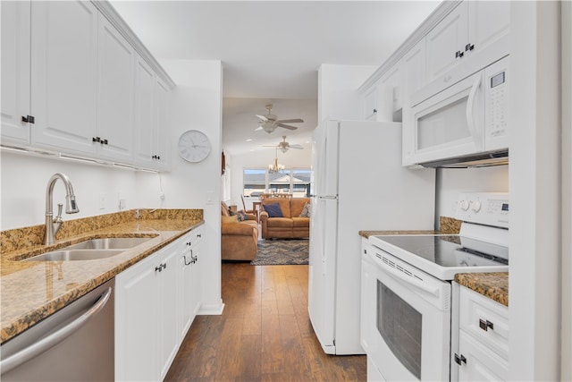 kitchen with white cabinetry, white appliances, dark hardwood / wood-style flooring, light stone countertops, and sink