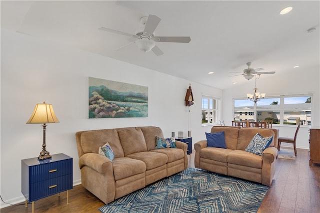 living room with vaulted ceiling, dark wood-type flooring, and ceiling fan with notable chandelier