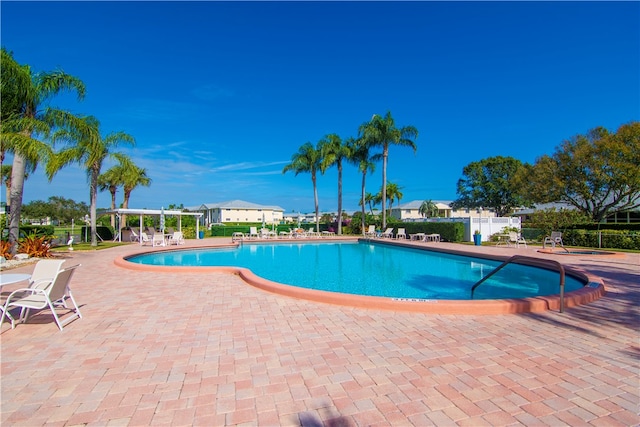 view of swimming pool with a patio and a pergola