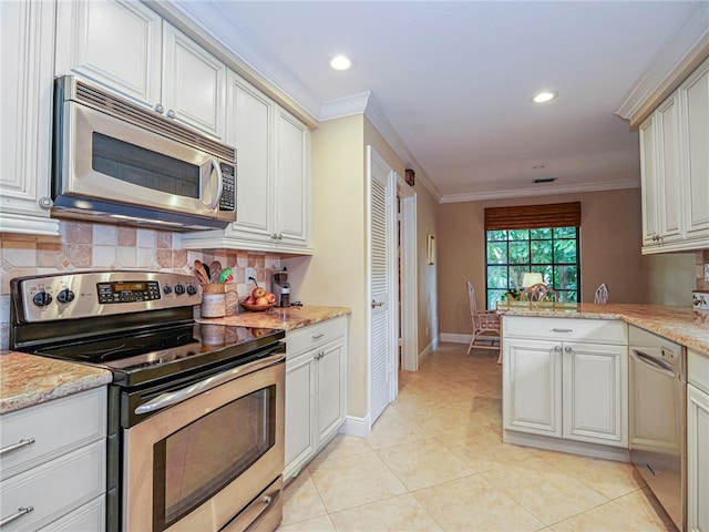 kitchen featuring kitchen peninsula, appliances with stainless steel finishes, ornamental molding, light tile patterned floors, and backsplash