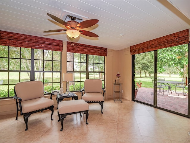 sunroom featuring ceiling fan