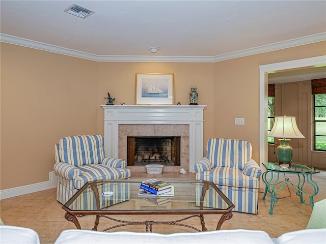 living room with light tile patterned flooring, a tiled fireplace, and ornamental molding