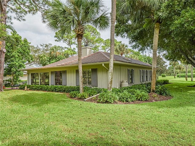 view of side of property with a lawn