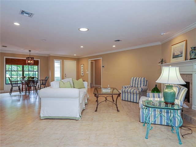 living room featuring a tiled fireplace and ornamental molding