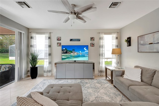 tiled living room featuring a healthy amount of sunlight and ceiling fan