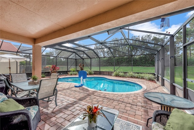 view of swimming pool with a lanai and a patio area