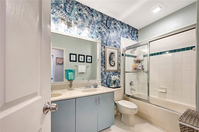 full bathroom with bath / shower combo with glass door, vanity, toilet, and tile patterned flooring