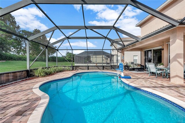 view of pool featuring a patio and glass enclosure