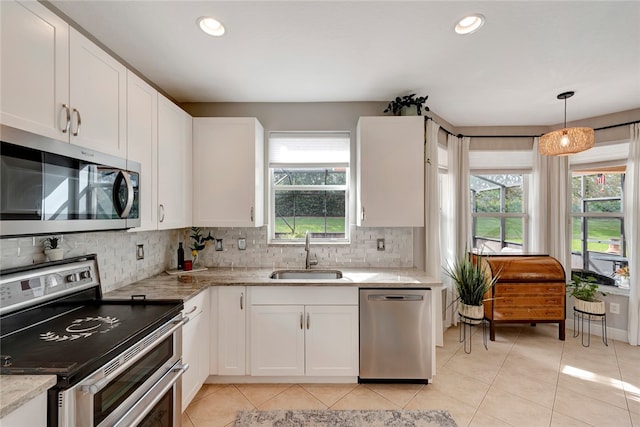 kitchen featuring white cabinetry, appliances with stainless steel finishes, sink, and plenty of natural light