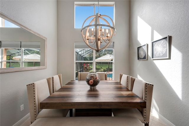 tiled dining area featuring a notable chandelier