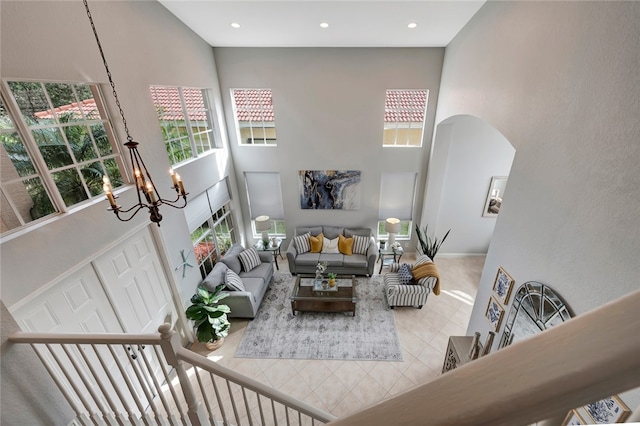 living room featuring a high ceiling and a chandelier