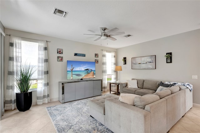 tiled living room featuring a wealth of natural light and ceiling fan