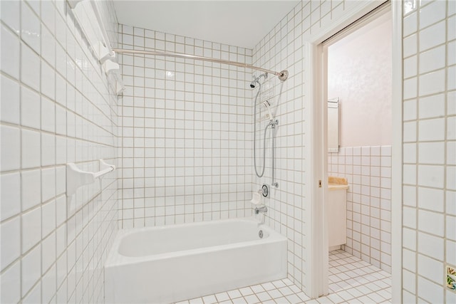 bathroom featuring tile walls, tile patterned flooring, and tiled shower / bath combo