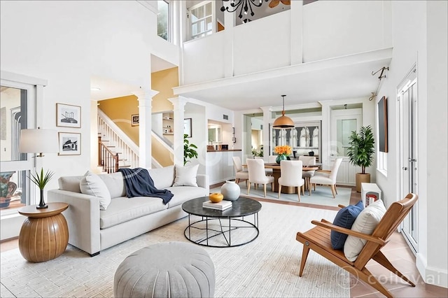 1401 Saint Davids Ln, Vero Beach, FL 32967 - living area with a high ceiling, stairway, baseboards, and wood finished floors