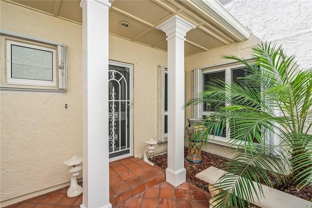 1401 Saint Davids Ln, Vero Beach, FL 32967 - doorway to property featuring stucco siding and a porch
