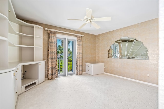 carpeted spare room with ceiling fan