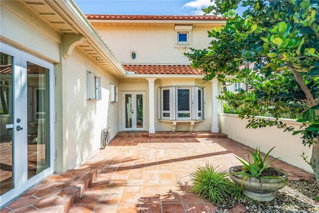 1401 Saint Davids Ln, Vero Beach, FL 32967 - rear view of house featuring french doors, a tile roof, stucco siding, and a patio