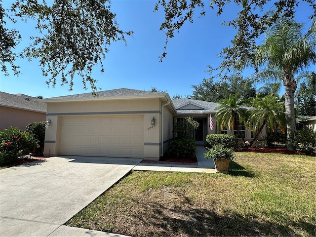 single story home featuring a front yard and a garage