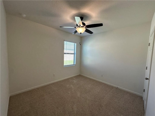 empty room featuring baseboards, carpet, and a ceiling fan