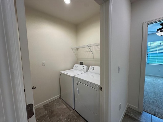 clothes washing area with washer and clothes dryer, laundry area, baseboards, and dark colored carpet