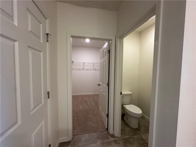 bathroom with baseboards and toilet