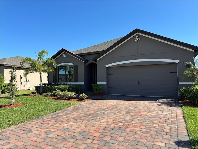 ranch-style house featuring a front yard, decorative driveway, a garage, and stucco siding