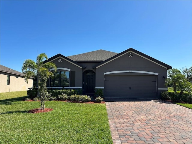 ranch-style house with a front lawn, decorative driveway, an attached garage, and stucco siding