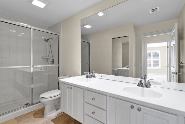 bathroom featuring an enclosed shower, vanity, and toilet